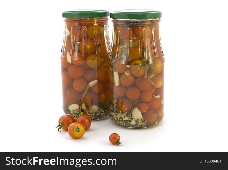 Small marinated tomatoes on a white background. Small marinated tomatoes on a white background.