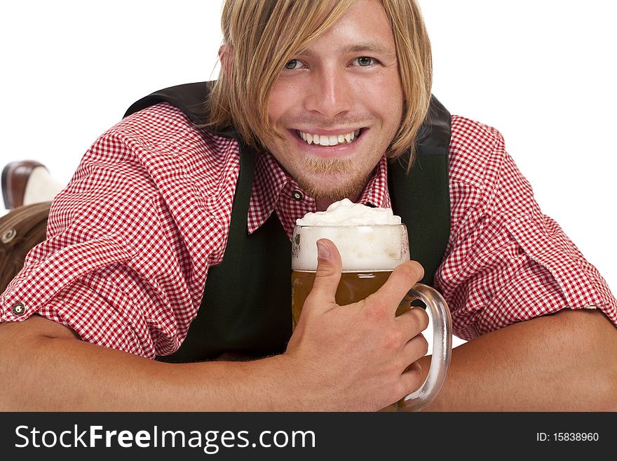 Man lying on floor holds oktoberfest beer stein