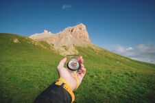 Male Hand With A Magnetic Compass Ea Against The Backdrop Of A Beautiful Landscape At Sunset. The Concept Of Navigating Stock Photography
