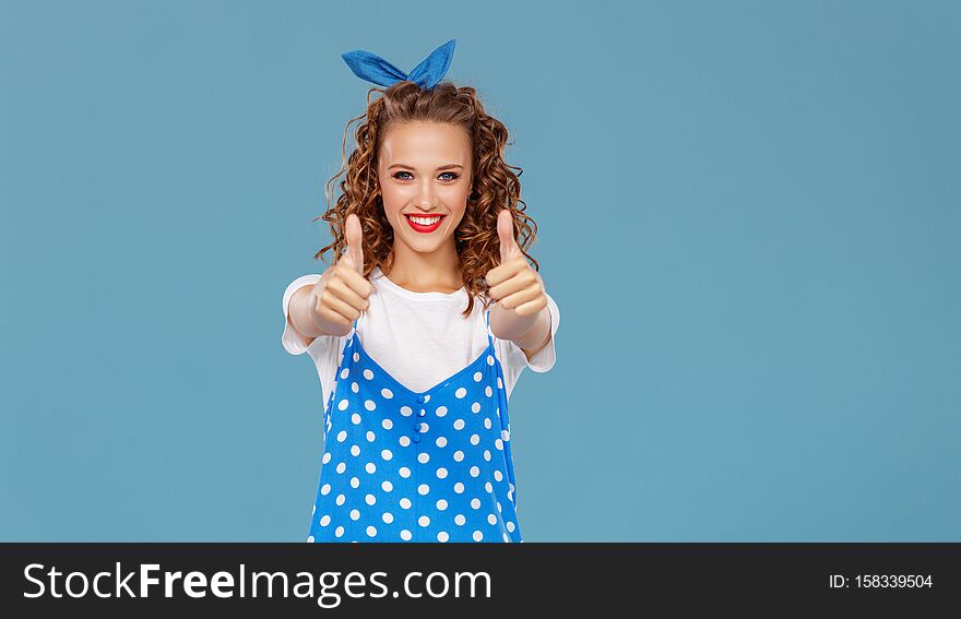 Young beautiful funny girl on colored blue background