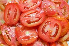 Red Sliced Tomatoes On Plate With Water Drops Royalty Free Stock Photo