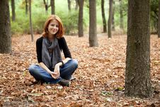 Beautiful Red-haired Girl In Autumn Park Royalty Free Stock Photos
