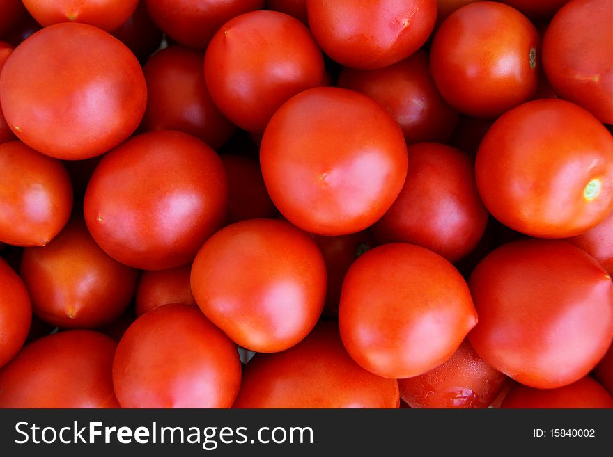 Organically grown red cherry tomatoes background. Organically grown red cherry tomatoes background