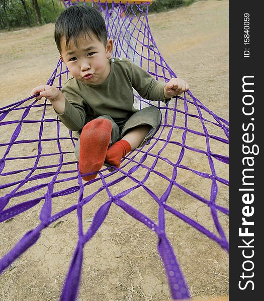 Boy Making Faces In Hammock