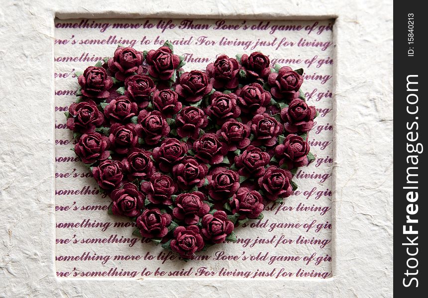 Paper flowers in heart form in wedding album. Paper flowers in heart form in wedding album