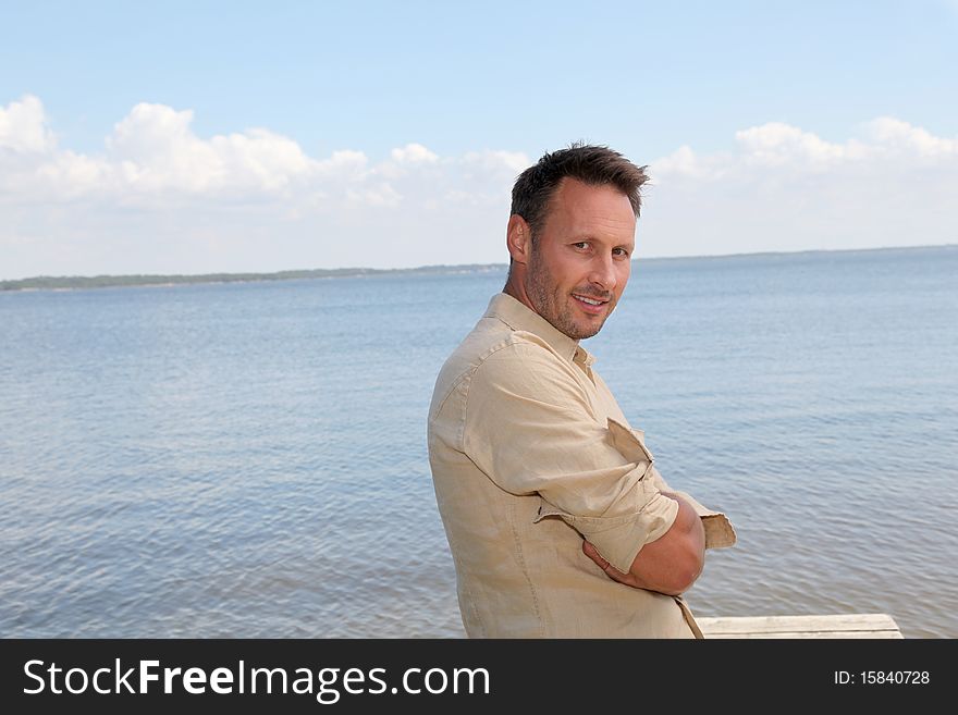 Man standing by a lake