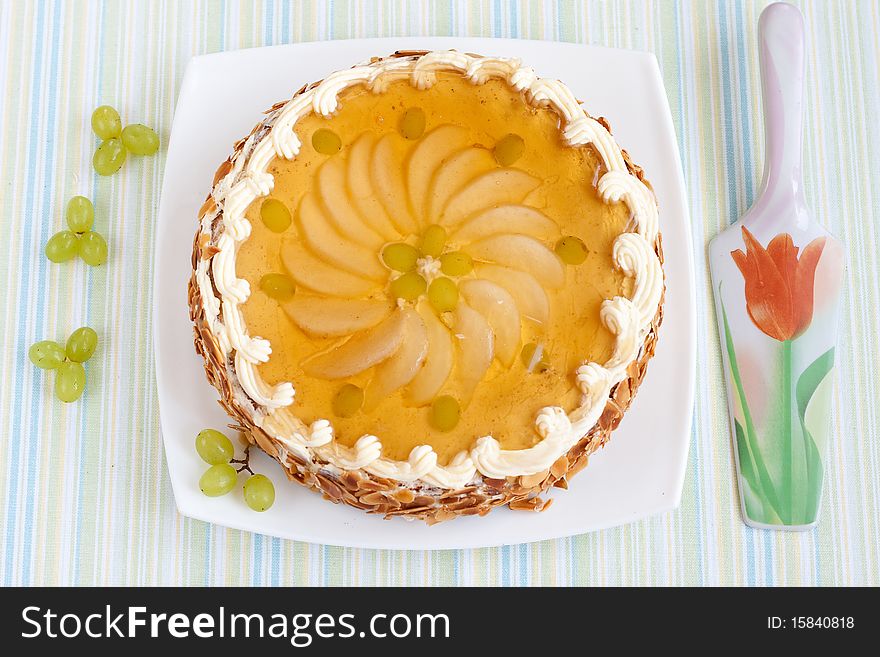 Whole cake decorated with fresh fruits with special spoon. Whole cake decorated with fresh fruits with special spoon