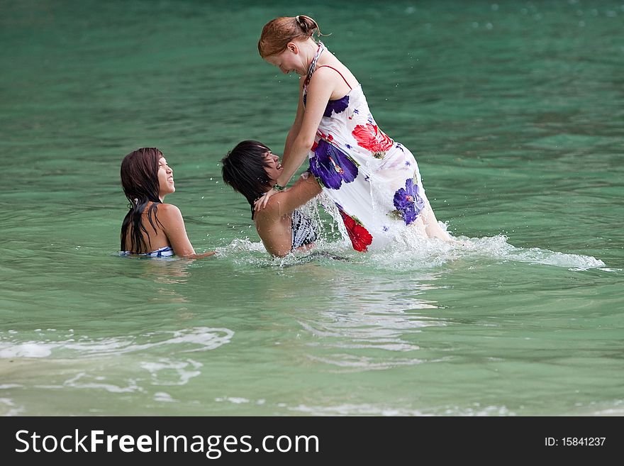 Girls swimming in the sea, fun on the beach in Thailand
