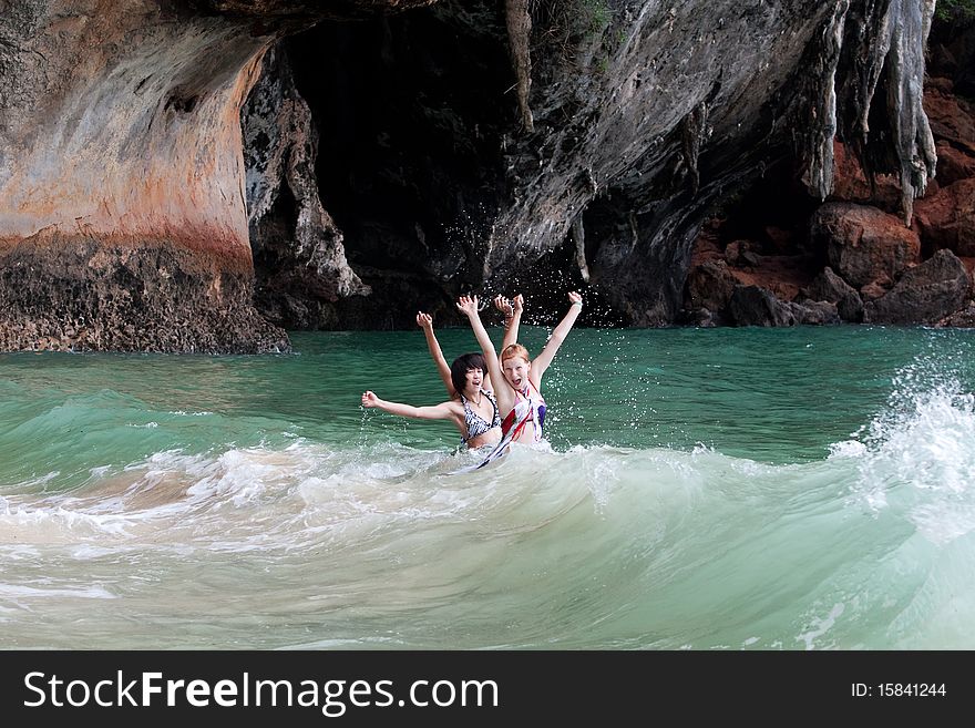Girls swimming in the sea, fun on the beach in Thailand
