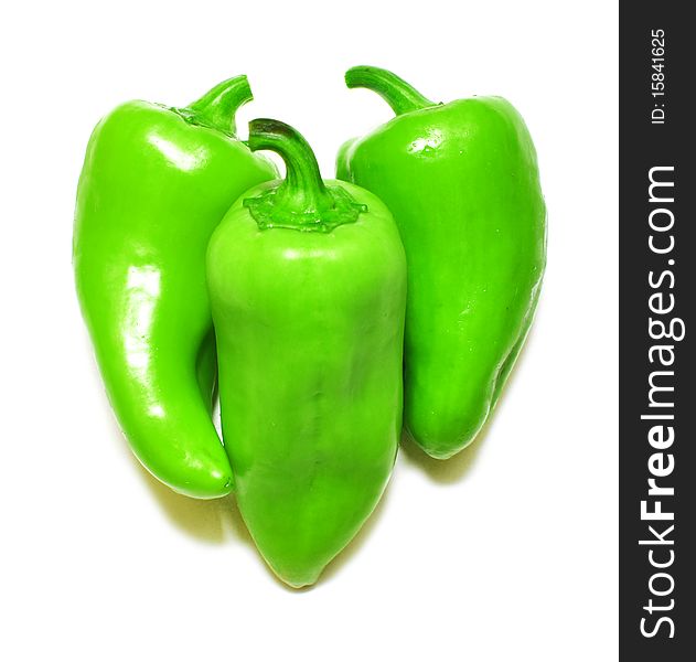 Three green peppers isolated on white background