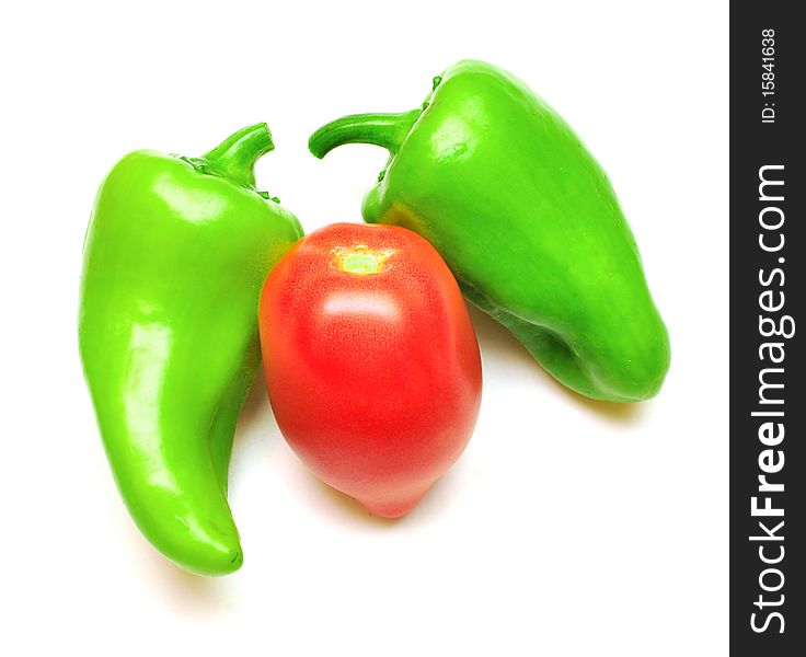 Green pepper and tomato on white background