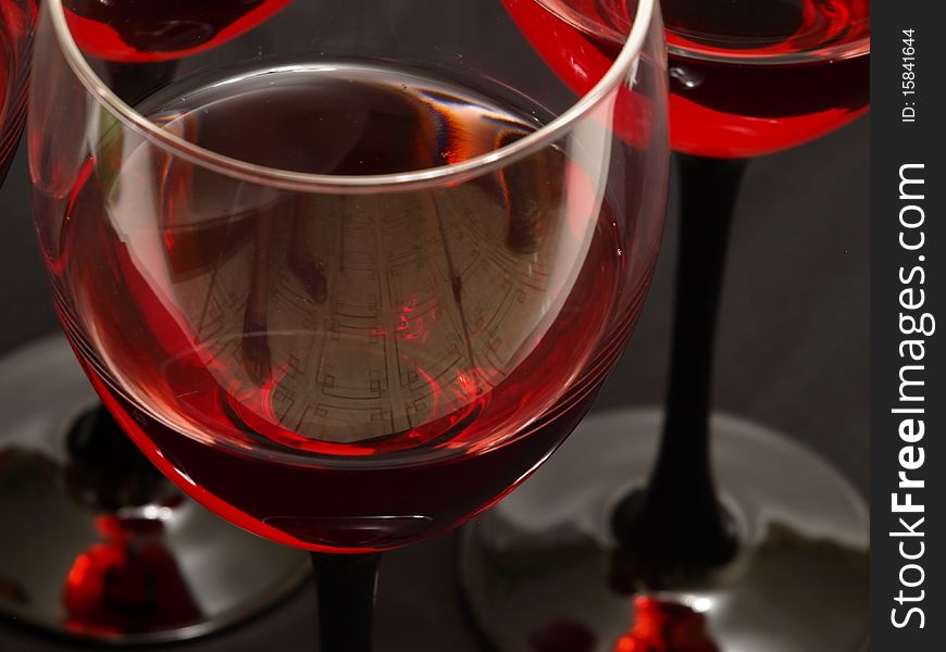Two glasses of red wine close-up over red backgrou