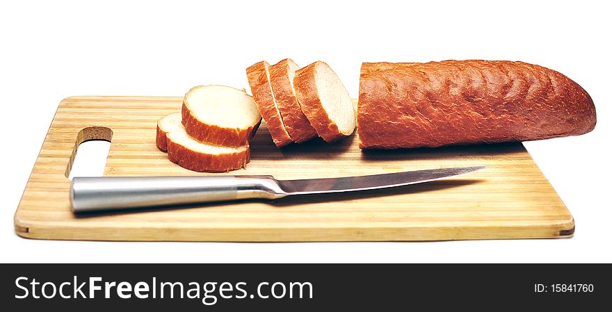 Baguette sliced with a knife isolated on white