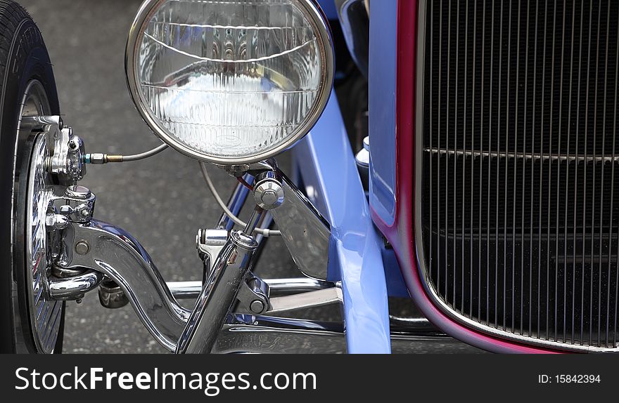 Closeup of a classic vintage car displayed outdoors.