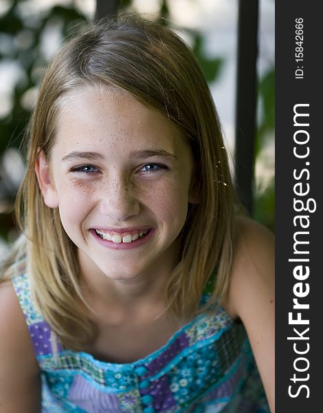 A young, pretty, preadolescent girl smiling at the camera and lauging. A young, pretty, preadolescent girl smiling at the camera and lauging.