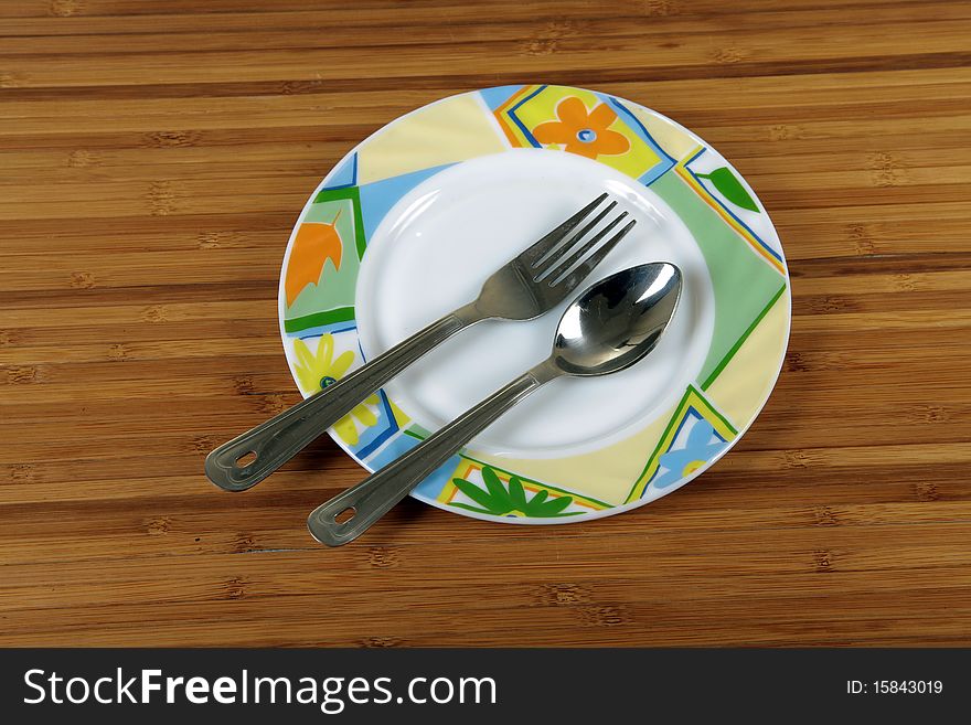 Empty plate whit fork and spoon on wooden background. Empty plate whit fork and spoon on wooden background.