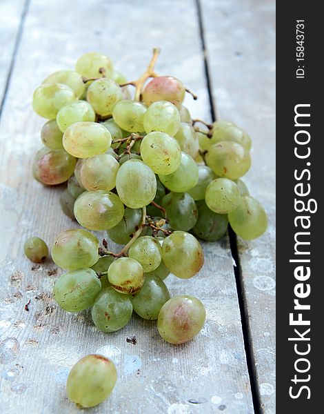 Green grapes on a wooden table