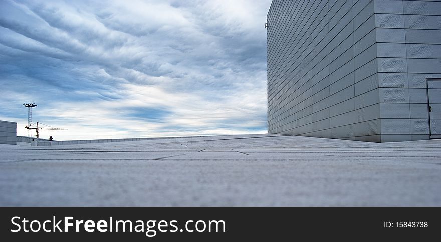 Walls of Oslo Opera House with a blue sky in a background