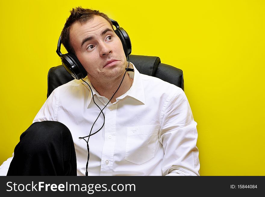 Young Business Man enjoying good, quality music to his headphones 02. Young Business Man enjoying good, quality music to his headphones 02