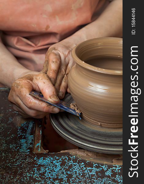 The hands of a potter, creating an earthen jar on the circle, close-ups. The hands of a potter, creating an earthen jar on the circle, close-ups