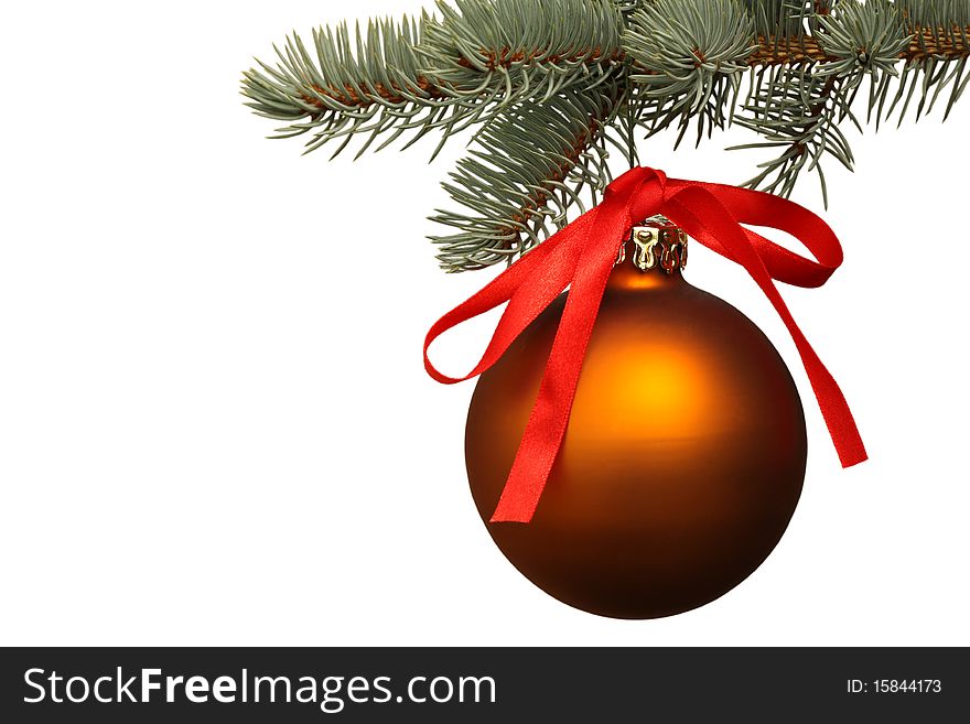 Matte gold Christmas ball hangs from pine branch on white background. Matte gold Christmas ball hangs from pine branch on white background.