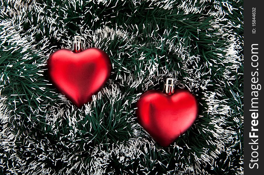 Christmas tree decorations. Toy in the shape of the heart and tinsel.