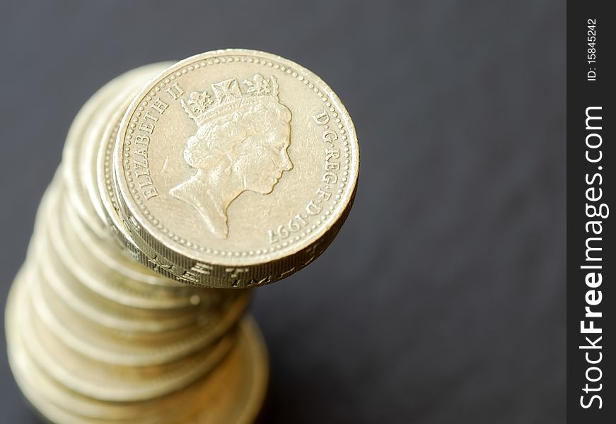 Stack of coins over grey textured background