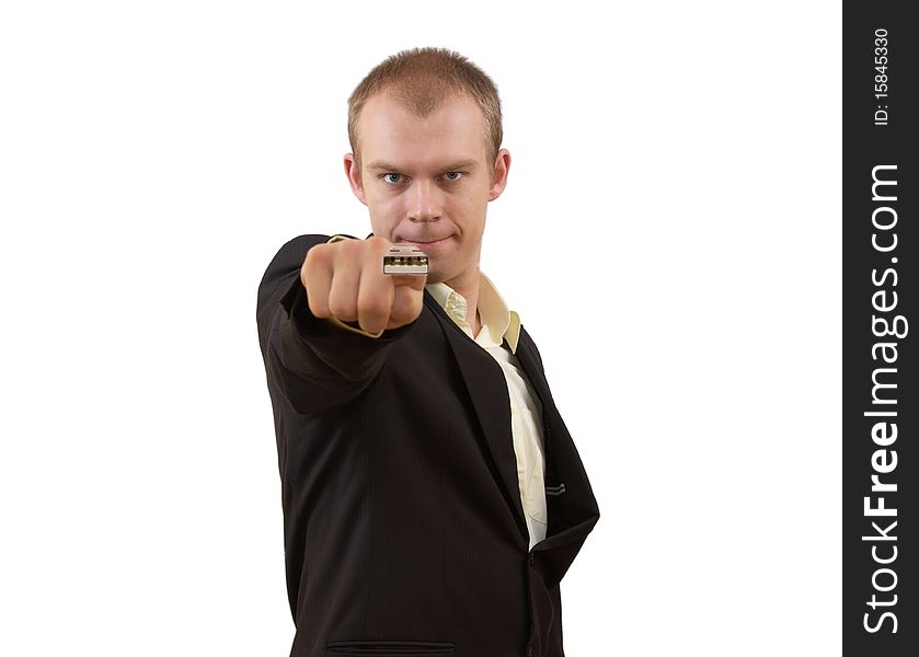 Young businessman in suit pointing in you with USB on his finger, isolated on white. Modern technology concept. Young businessman in suit pointing in you with USB on his finger, isolated on white. Modern technology concept