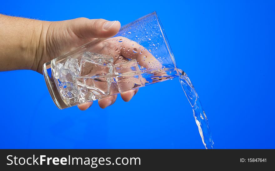 Fresh coolness water on the blue background. Fresh coolness water on the blue background