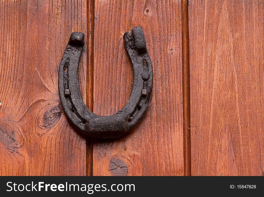A horseshoe on an old wooden door