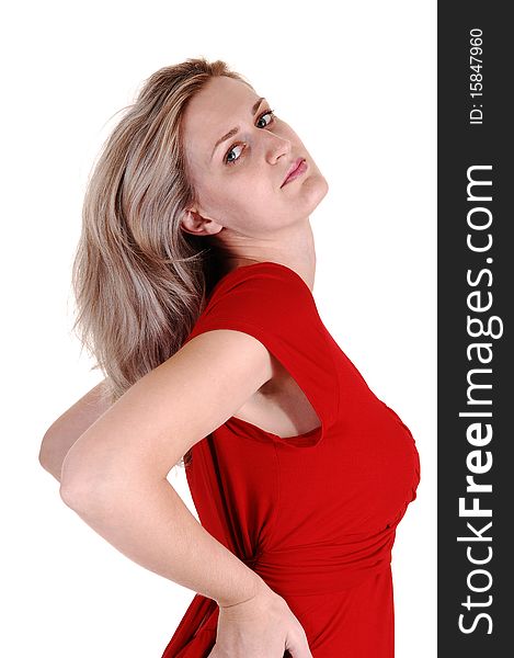 An very pretty tall woman in a red dress standing in the studio with with her long white blond hair, looking into the camera, for white background. An very pretty tall woman in a red dress standing in the studio with with her long white blond hair, looking into the camera, for white background.