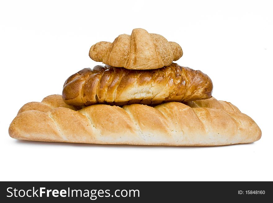 Fresh bread rolls in a basket on whitete