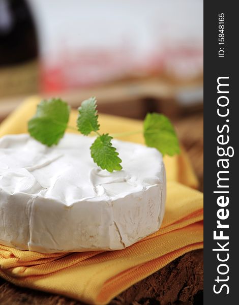 Small wheel of white rind cheese - closeup. Small wheel of white rind cheese - closeup