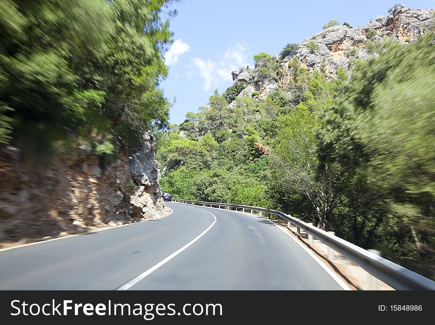 Driving along the road between mountains