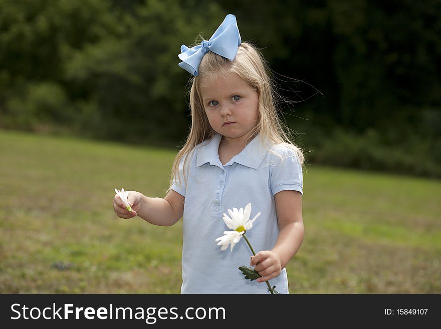 Little Girl Holding a Flower