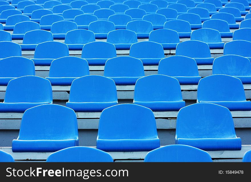 Empty blue plastic stadium seats