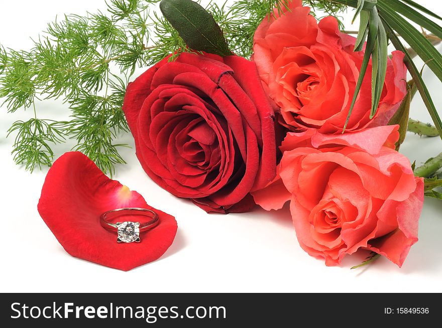 Diamond ring and roses on white background. Diamond ring and roses on white background