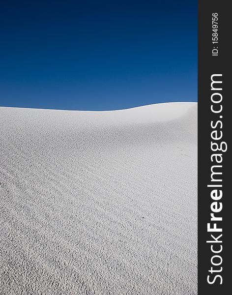 A white sand dune in a vast desert. A white sand dune in a vast desert