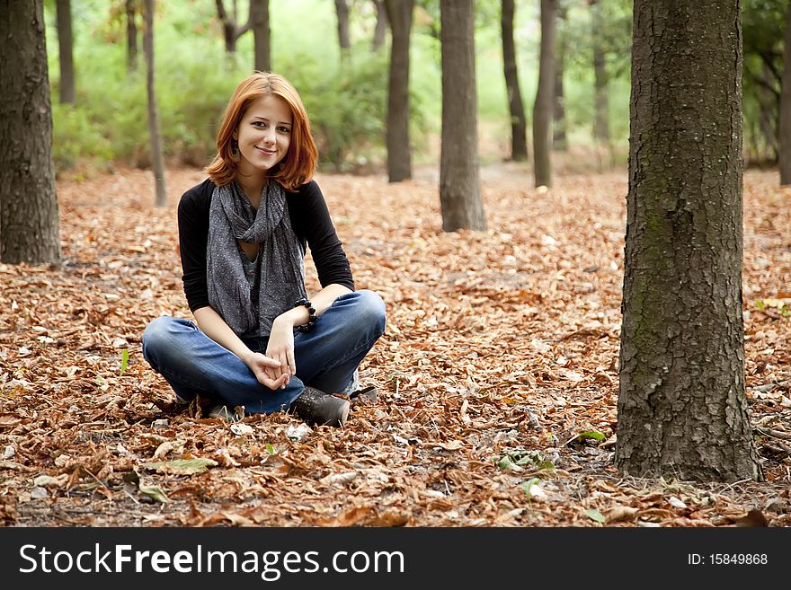 Beautiful Red-haired Girl In Autumn Park