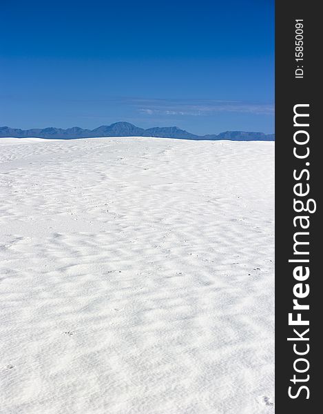 Waves of sand shifted by harsh winds in a vast desert. Waves of sand shifted by harsh winds in a vast desert