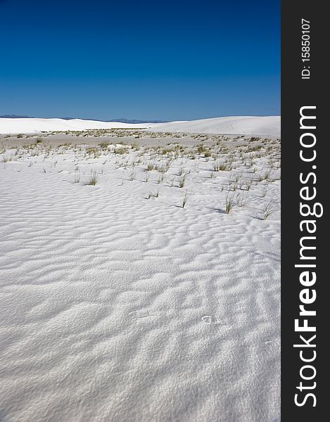 Waves of sand shifted by harsh winds in a vast desert. Waves of sand shifted by harsh winds in a vast desert