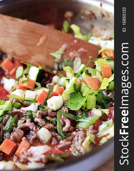 Stir frying minced meat and vegetables in a saucepan. Stir frying minced meat and vegetables in a saucepan