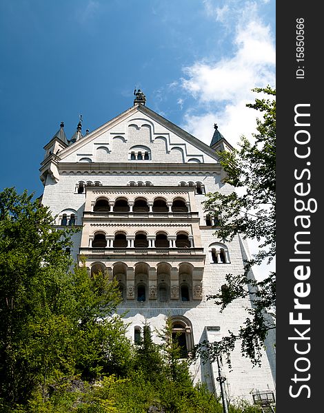 Wall of a castle in the forest with a balcony