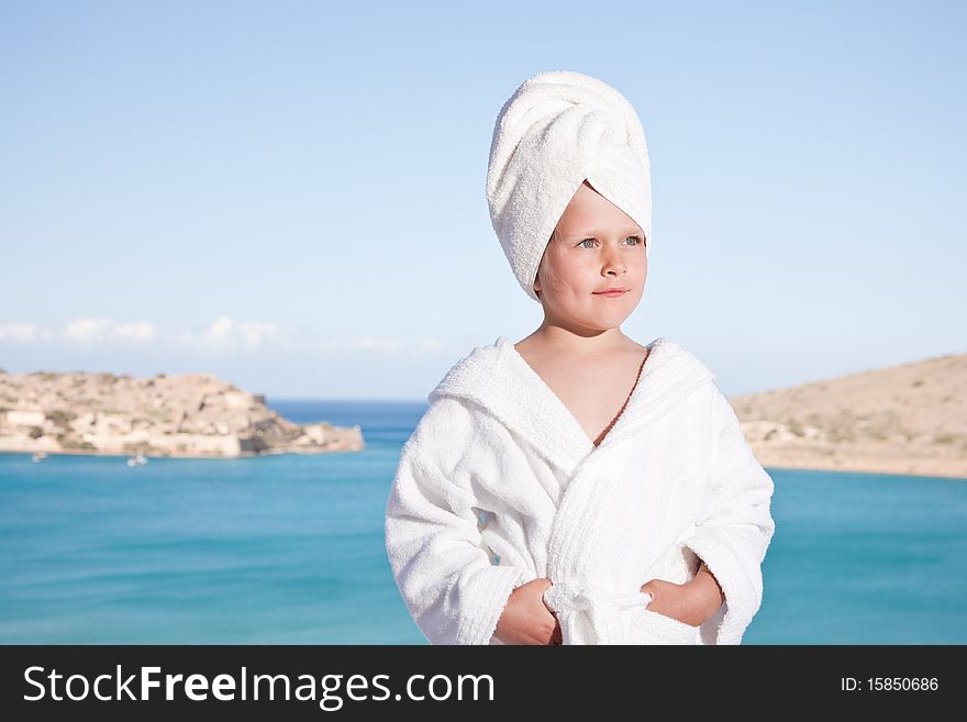 Little girl with towel on head in white bathrobe
