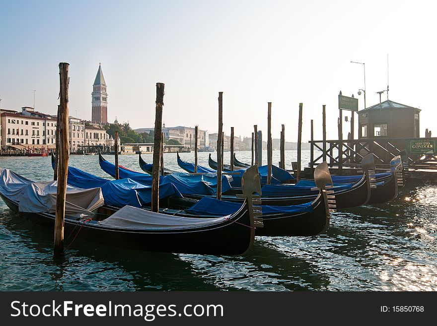 Cased gondolas with a San Marco tower on the backgroup. Cased gondolas with a San Marco tower on the backgroup