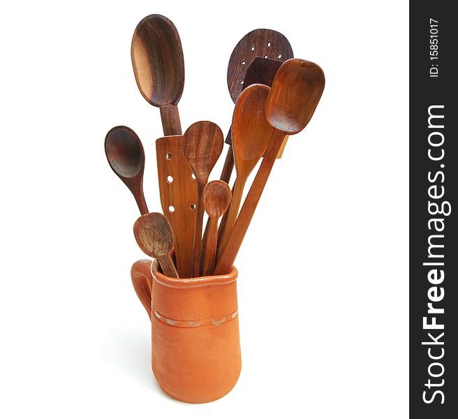 A group of handcrafted wooden spoons for cooking in a jar. A group of handcrafted wooden spoons for cooking in a jar