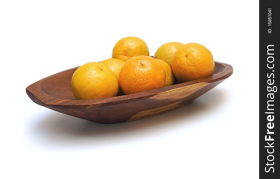 Handcrafted wooden fruit dish with oranges isolated on white. Handcrafted wooden fruit dish with oranges isolated on white