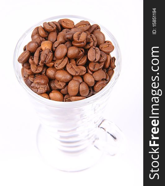 Glass of coffee beans on white background