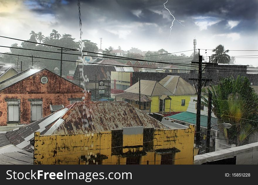 A tropical rainstorm over simple village with tin roofs