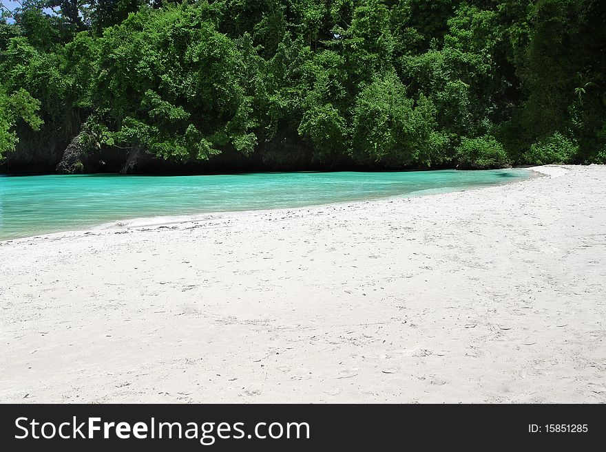 Landscape photo of a quiet beautiful white sand beach with clear turquoise waters. Landscape photo of a quiet beautiful white sand beach with clear turquoise waters